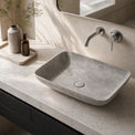 Bathroom vanity with a concrete sink and faucet