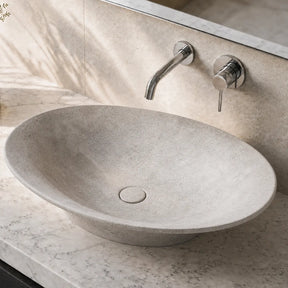Bathroom vanity with a stone Concrete sink and modern faucet.