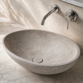 Bathroom vanity with a stone concrete sink and faucet