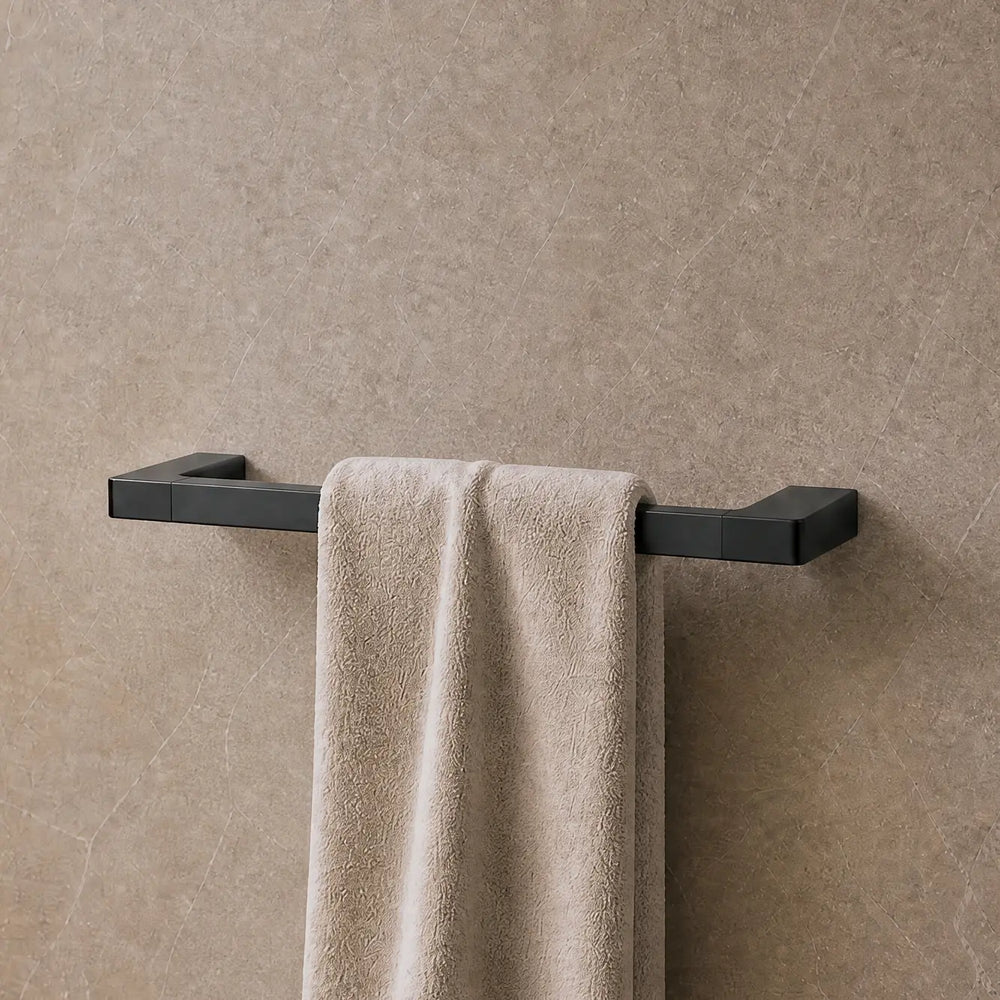 Towel hanging on a rack in a modern bathroom with neutral tones.