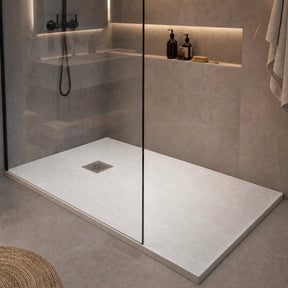 Modern shower with a flat floor and built-in shelves in a bathroom setting.